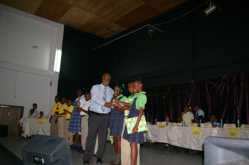 Premier of Nevis, Hon. Joseph Parry and winners of the Joycelyn Liburd school: Miss Kervinicia Webbe, Mr.Makebou Tross and standby Miss. Chelcia Burke